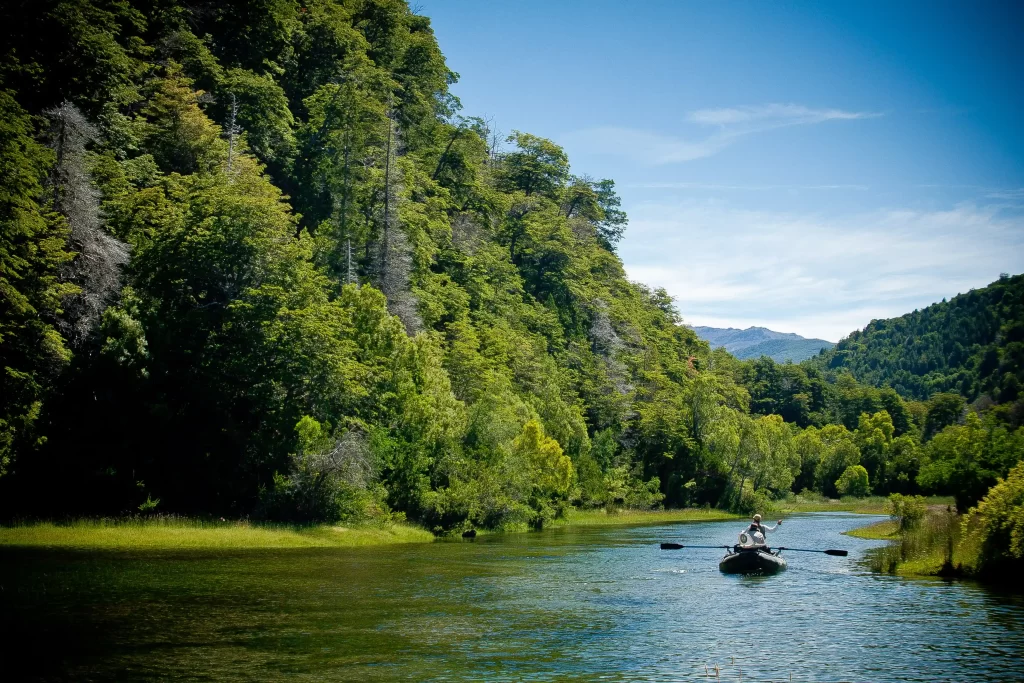 A guided drift boat rounds a bend on a Patagonia river